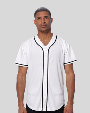 Man wearing a white baseball jersey with black trim on a gray background